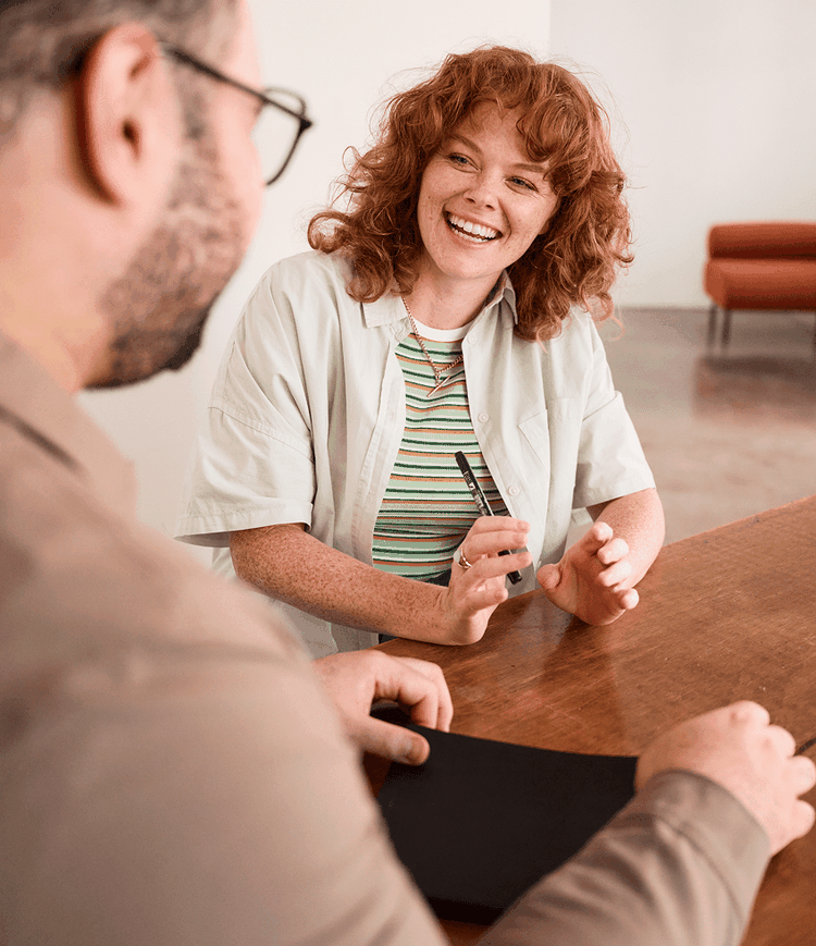 Two colleagues sitting at a table and talking