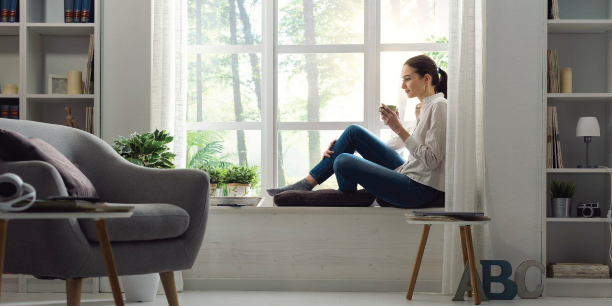 Woman relaxing at home and having coffee