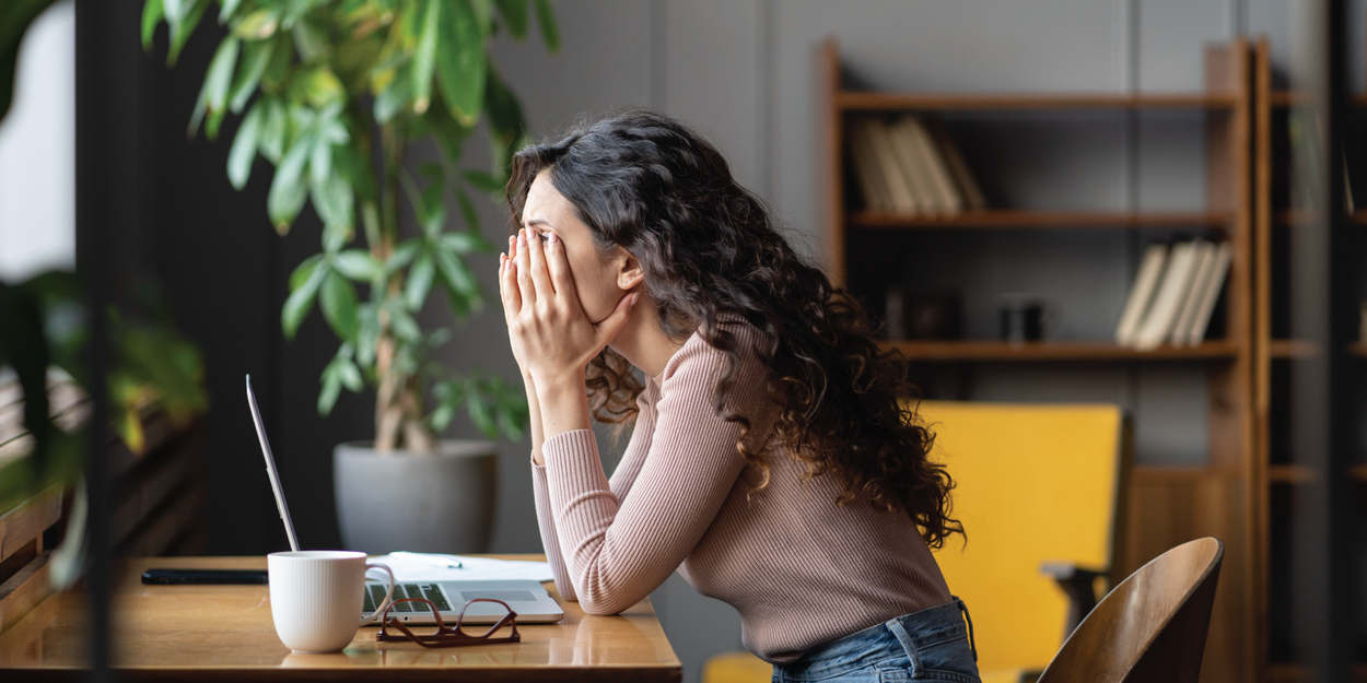 Sad woman sitting at a desk